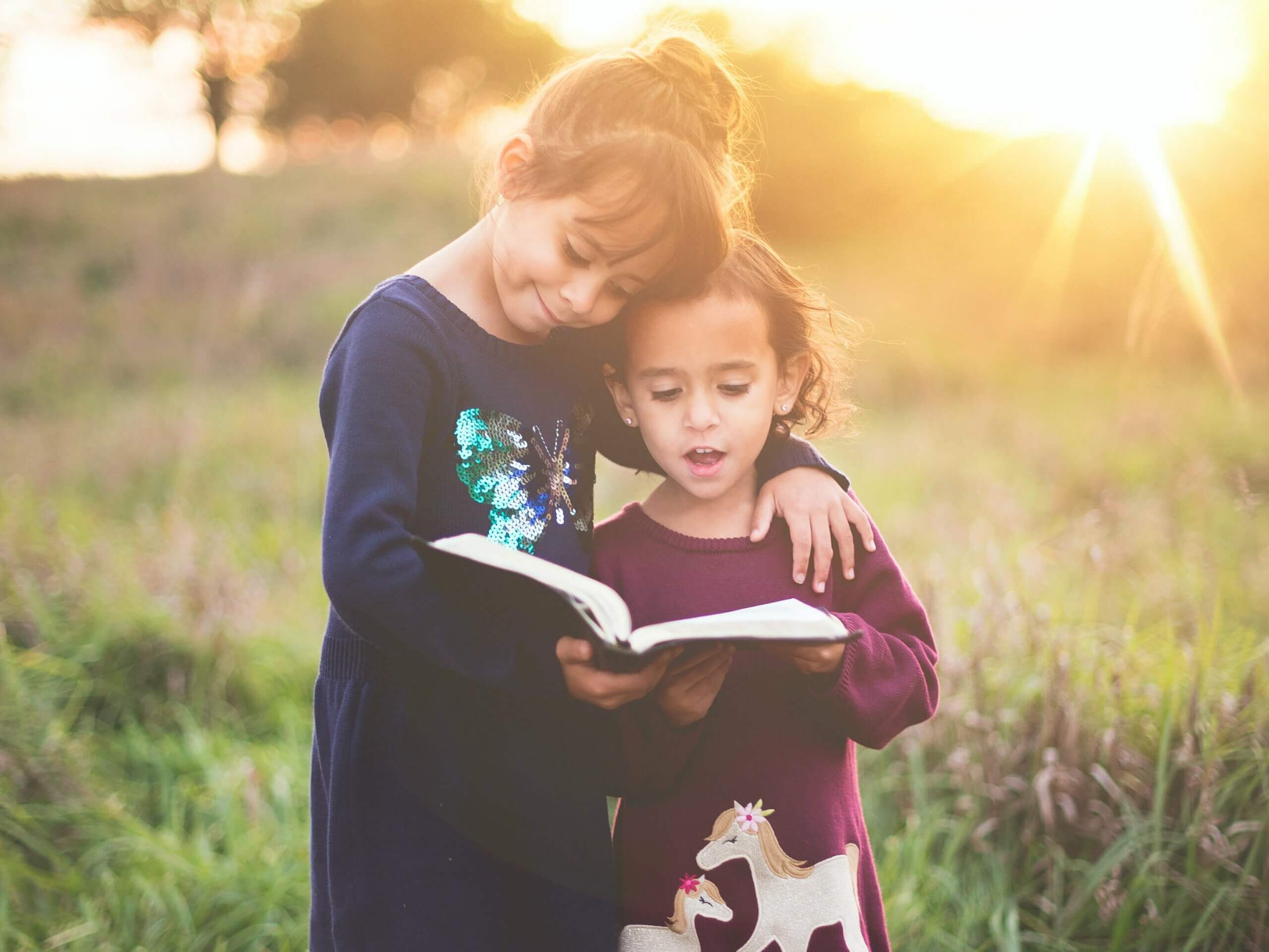 two girls reading aloud
